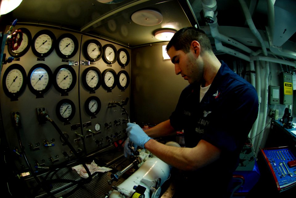 US Navy 090327-N-0096C-014 Aviation Structural Mechanic 2nd Class Brandon Fournier, from Fall River, Mass., tests an auxiliary power unit accumulator