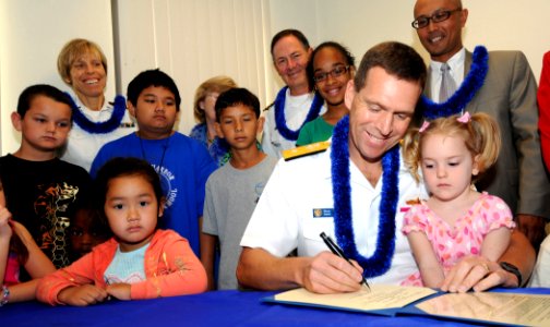 US Navy 090330-N-9758L-044 Rear Adm. Dixon Smith, commander, Navy Region Hawaii and Commander, Naval Surface Group Middle Pacific, signs the Month of the Military Child and Child Abuse Prevention Proclamation photo