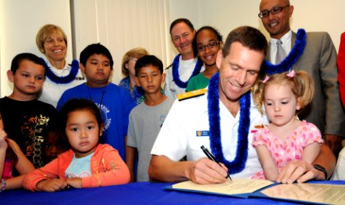 US Navy 090330-N-9758L-044 Rear Adm. Dixon Smith, commander, Navy Region Hawaii and Commander, Naval Surface Group Middle Pacific, signs the Month of the Military Child and Child Abuse Prevention Proclamation