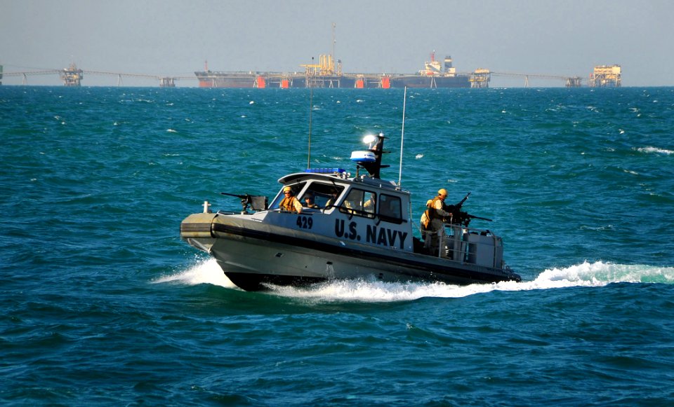 US Navy 090326-N-4774B-041 A Navy patrol boat assigned to Inshore Boat Unit (IBU) 22 approaches the guided-missile cruiser USS Lake Champlain (CG 57) as it patrols the waters surrounding the Al Basra Oil Terminal off the coast
