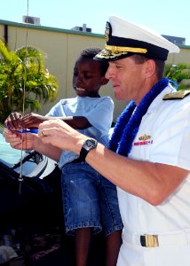 US Navy 090330-N-9758L-079 Rear Adm. Dixon Smith, commander, Navy Region Hawaii and Commander, Naval Surface Group Middle Pacific, signs the Month of the Military Child and Child Abuse Prevention Proclamation