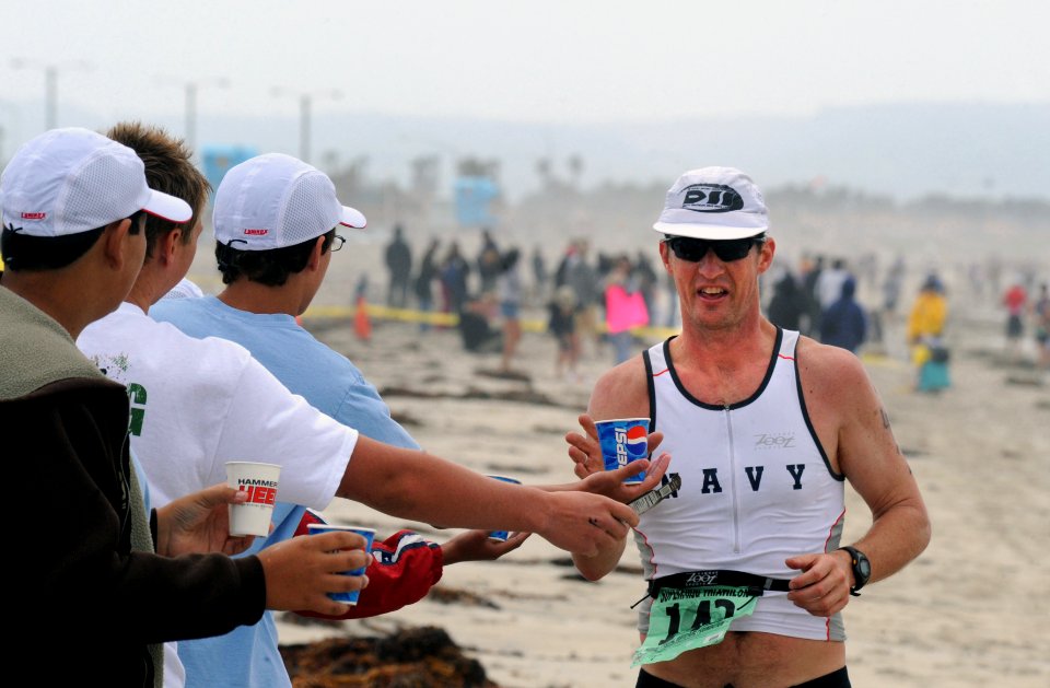 US Navy 090329-N-2959L-112 A competitor reaches for water while along the beach during the 31st annual SUPERFROG Triathlon at Silver Strand State Beach