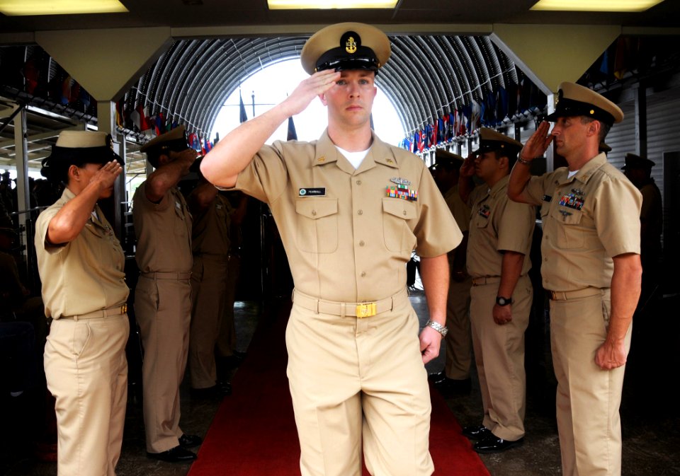 US Navy 090327-N-9758L-083 Chief Operations Specialist Joshua Pearsall, assigned to Afloat Training Group Middle Pacific, is piped aboard after receiving his anchors during a special Chief Pinning Ceremony at the Commander, U.S