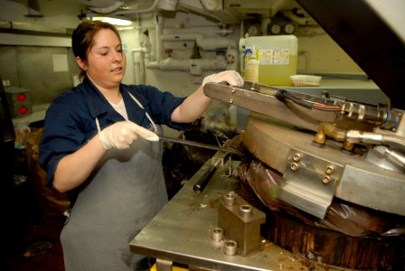 US Navy 090327-N-2475A-005 Information Systems Technician Seaman Tiffany Conrad, from Camden, Tenn., processes plastic waste in a waste processing room