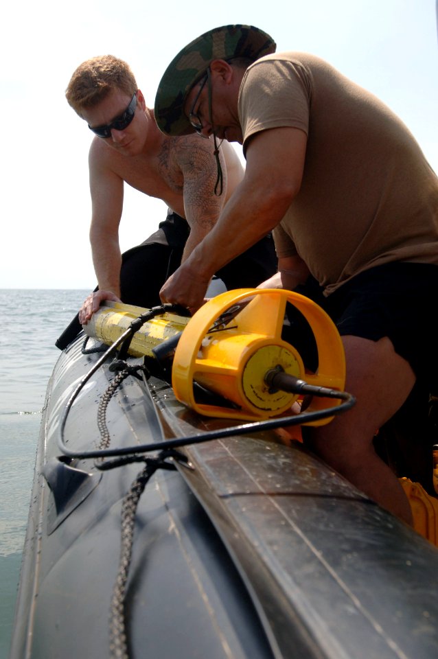 US Navy 090328-N-5242D-063 xplosive Ordnance Disposal Technician 2nd Class John Handrahan and Chief Sonar Technician (Surface) Manny Ybarra lower a towed side-scan sonar into Africa's Lake Victoria