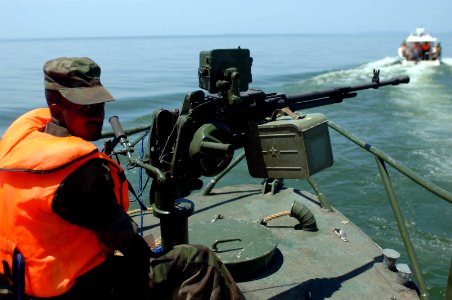 US Navy 090327-N-5242D-135 Uganda Peoples' Defense Force Pvt. Joriam Taremwa mans a machine gun at the bow of a Ugandan patrol boat in Africa's Lake Victoria where an Ilyushin 76 crashed March 9