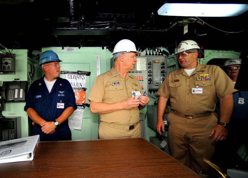 US Navy 090331-N-8273J-272 Chief of Naval Operations (CNO) Adm. Gary Roughead, center, speaks with Quartermaster 2nd Class Jonathan Voldberg, left, and Commanding Officer Capt. Robert George Kopas during a visit to the amphibio