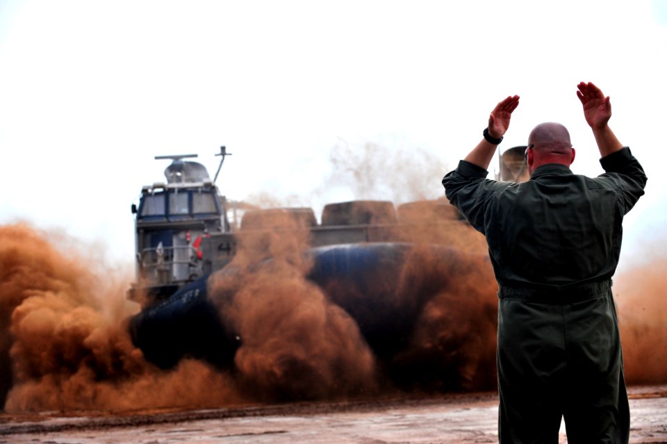 US Navy 090401-N-0506A-094 A Sailor assigned to Assault Craft Unit 5 (ACU-5) directs a landing craft air cushion during an exercise near Camp Lemonier, Djibouti