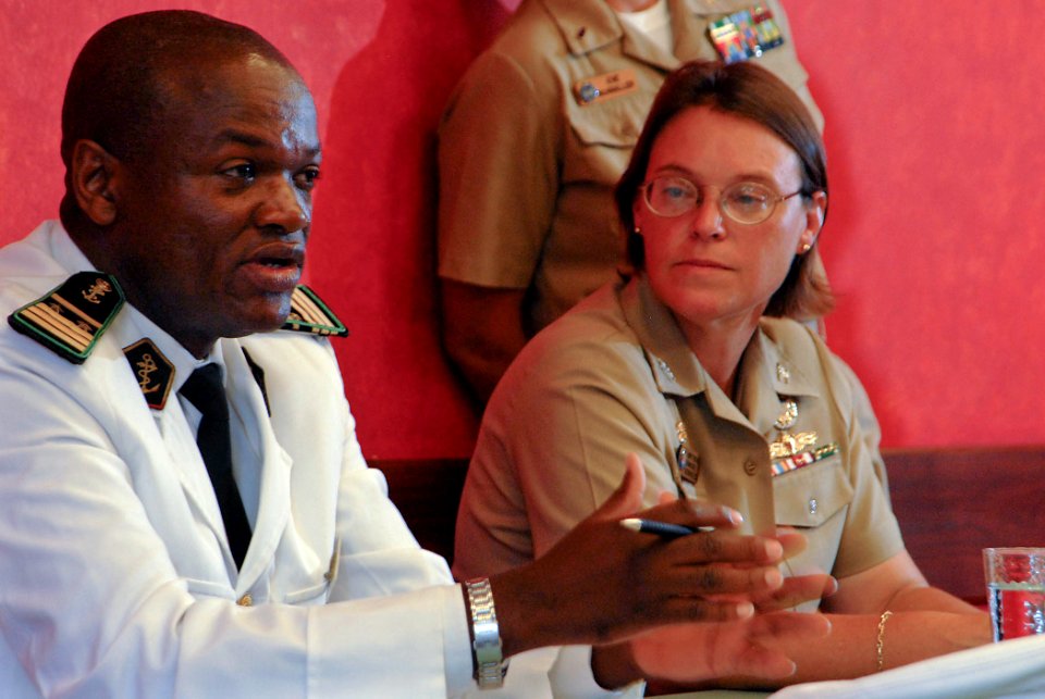 US Navy 090402-N-1688B-076 Cameroon Armed Forces Navy Lt. Cmdr. Hamadou Lame answers a question during a press conference in Douala, Cameroon as Capt. Cindy Thebaud, commander of Africa Partnership Station Nashville looks on