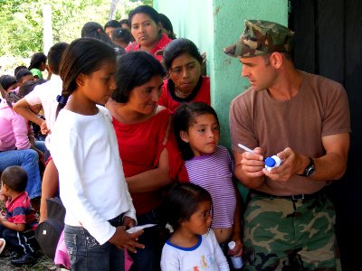 US Navy 090401-N-1580K-532 Hospital Corpsman 2nd Class Michael Behrendt, from Corpus Christi, Texas, explains the uses of certain pharmaceutical prescriptions to villagers during a Beyond the Horizon humanitarian assistance exe photo