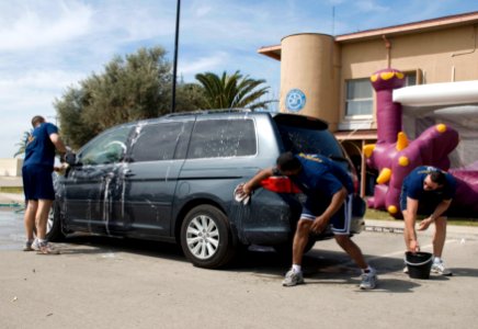 US Navy 090402-N-4974K-003 Gunners Mate 1st Class Kirk Reiner, Aviation Boatswain's Mate 1st Class Wonderful Parker and Storekeeper 1st Class Chris Arnold wash cars at the First Class Petty Officer Association car wash during t