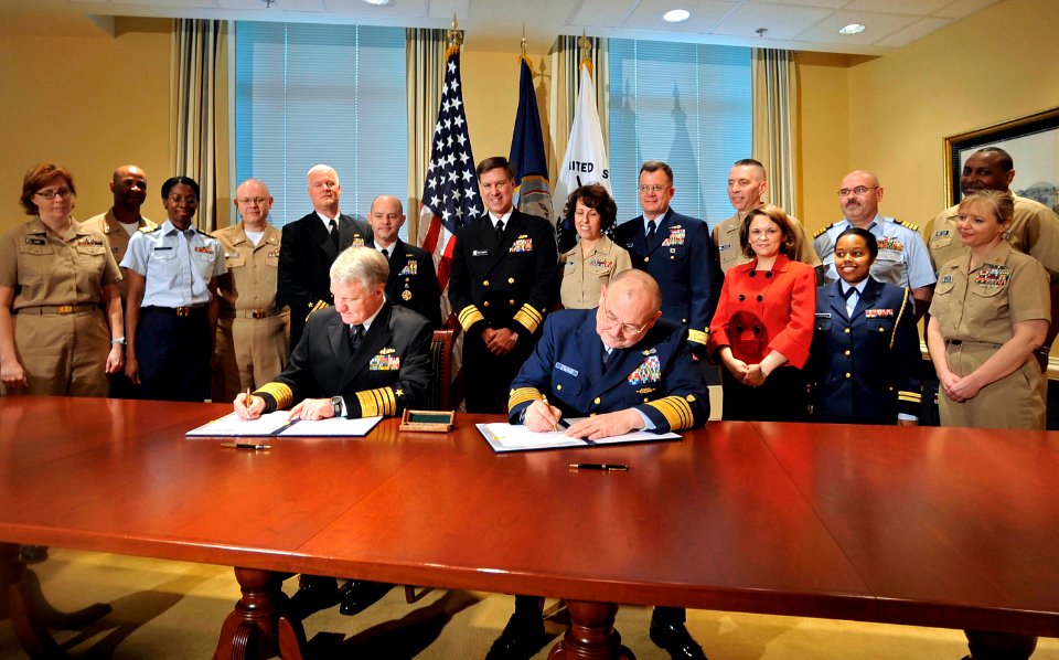 US Navy 090401-N-8273J-003 Chief of Naval Operations (CNO) Adm. Gary Roughead, left, and Coast Guard Commandant Adm. Thad W. Allen sign a memorandum of agreement for the Safe Harbor program during a signing ceremony at the Pent