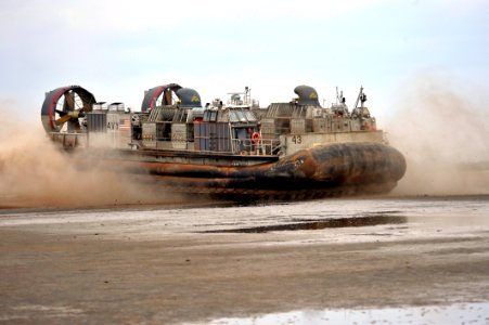 US Navy 090401-N-0506A-559 A landing craft air cushion from Assault Craft Unit (ACU) 5 leaves a beach during an exercise near Camp Lemonier, Djibouti photo