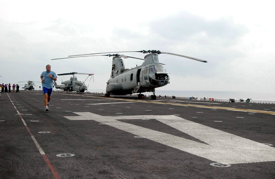 US Navy 090401-N-6410J-042 Aviation Support Equipment Technician 1st Class Ronald Rimorin runs on the flight deck of the amphibious assault ship USS Boxer (LHD 4)