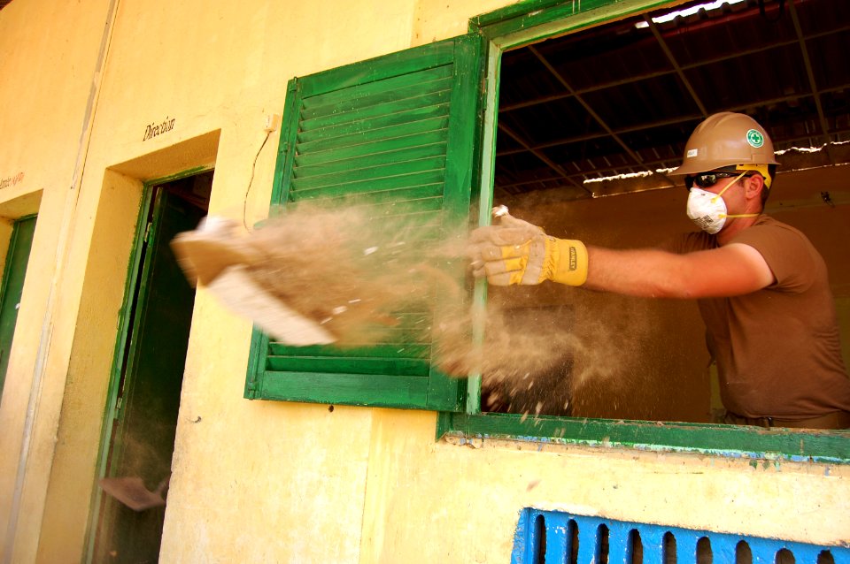 US Navy 090404-N-1057H-116 Builder Constructionman Recruit David Kelly, assigned to Naval Mobile Construction Battalion (NMCB) 11, Detachment Horn of Africa, removes debris at the Ecole Ali Sabieh Primary School