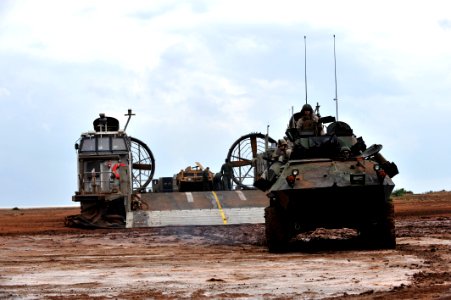 US Navy 090401-N-0506A-386 A light armored vehicle disembarks from a landing craft air cushion (LCAC) after landing on the beach during an exercise near Camp Lemonier, Djibouti