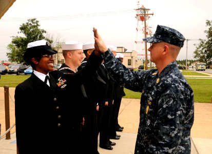 US Navy 090331-N-2070C-001 Master Chief Petty Officer of the Navy (MCPON) Rick West high-fives Naval Air Station Whiting Field Sailor of the Year Yeoman 1st Class Aritha Gregory