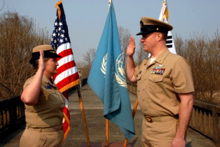 US Navy 090401-N-9573A-004 Capt. Deidre McLay, Chief of Staff for Commander, U.S. Naval Forces Korea, re-enlists Chief Personnel Specialist Brian Robinson, from Villa Grove, Ill., on the Bridge of No Return at the Demilitarized