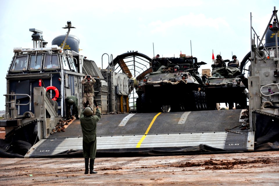 US Navy 090401-N-0506A-153 A light armored vehicle disembarks from a landing craft air cushion (LCAC) after landing on the beach during an exercise near Camp Lemonier, Djibouti