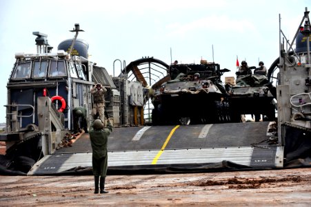 US Navy 090401-N-0506A-153 A light armored vehicle disembarks from a landing craft air cushion (LCAC) after landing on the beach during an exercise near Camp Lemonier, Djibouti