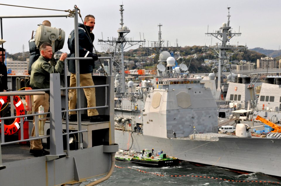 US Navy 090402-N-7478G-026 Capt. Thom W. Burke, commanding officer of the amphibious command ship USS Blue Ridge (LCC 19) looks onward with a Yokosuka harbor pilot as Blue Ridge gets underway