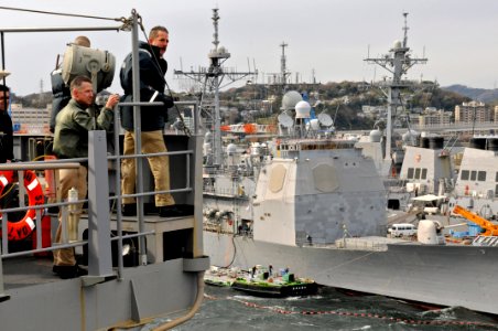 US Navy 090402-N-7478G-026 Capt. Thom W. Burke, commanding officer of the amphibious command ship USS Blue Ridge (LCC 19) looks onward with a Yokosuka harbor pilot as Blue Ridge gets underway