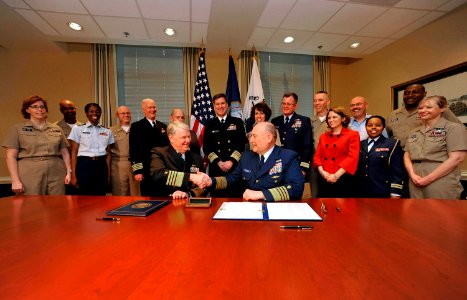 US Navy 090401-N-8273J-006 Chief of Naval Operations (CNO) Adm. Gary Roughead, left, and Commandant of the Coast Guard Adm. Thad W. Allen shake hands after signing a memorandum of agreement for the Safe Harbor program during a