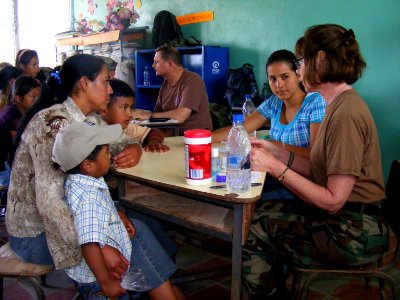 US Navy 090401-N-1580K-562 Navy nurse Capt. Anne White and Honduran translator Sheila Garcia explain medical procedures to villagers from Aguacatal during the Beyond the Horizon humanitarian assistance exercise in Honduras