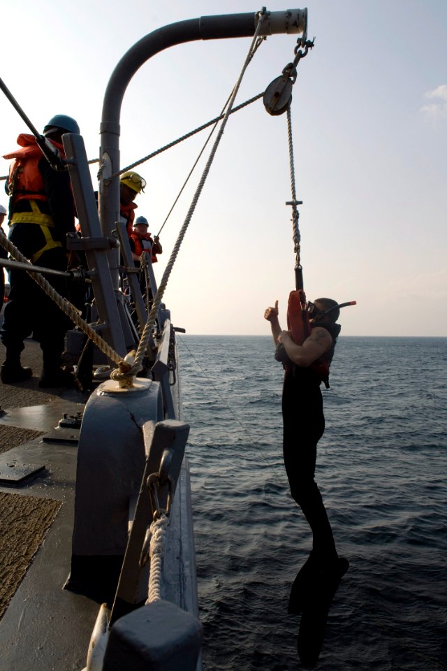 US Navy 090401-N-9123L-002 Search-and-Rescue Swimmer Gunner's Mate 2nd Class Antonio Rodriguez, from Los Angeles, signals he is ready to be lowered to line handlers