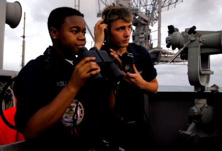 US Navy 090407-N-6538W-284 Seaman Nathaniel Anderson, right, from Spring Hill, Tenn., and Boatswain's Mate Seaman Recruit Courtney Pollard, from Fort Worth, Texas, use a sound powered phone to report surface contacts