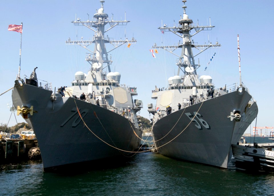 US Navy 090402-N-8534H-001 A large harbor tugboat assists the guided-missile destroyer USS John S. McCain (DDG 56) as it moors abreast of the guided-missile USS Hopper (DDG 70)
