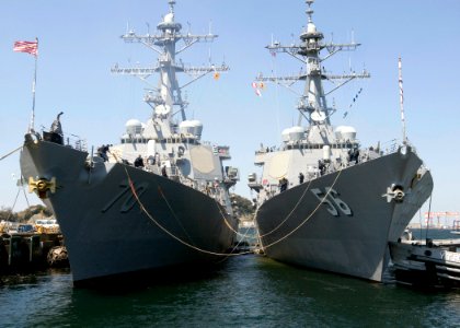 US Navy 090402-N-8534H-001 A large harbor tugboat assists the guided-missile destroyer USS John S. McCain (DDG 56) as it moors abreast of the guided-missile USS Hopper (DDG 70)