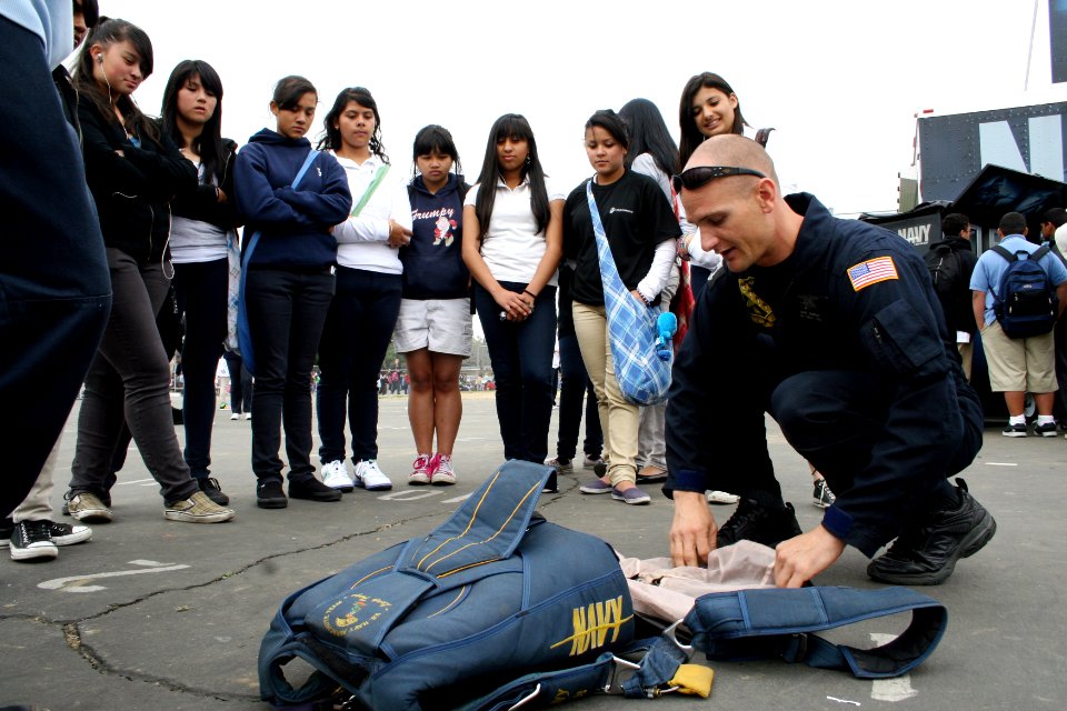 US Navy 090402-N-5366K-109 Special Warfare Operator 1st Class (SEAL) John Murray, assigned to the U.S. Navy Parachute Team, shows students how to pack his parachute