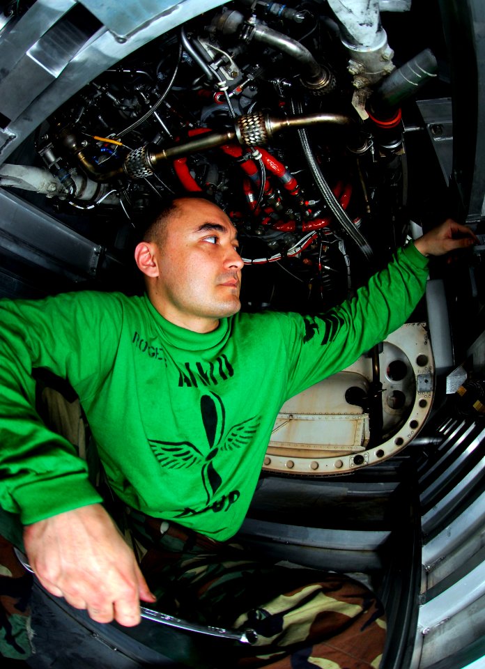 US Navy 090407-N-9928E-031 Aviation Machinist's Mate 1st Class Johnny Rogers, from Ft. Walton Beach, Fla., tightens down an engine stand holding a General Electric 404-400 jet engine from an F-A-18C Hornet