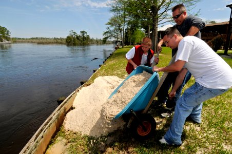 US Navy 090404-N-5328N-195 Volunteers from the Center for Information Dominance (CID) Corry Station in Pensacola help reinforce the bulkhead in the back yard of Lee Jones after torrential rains swelled the Blackwater River and