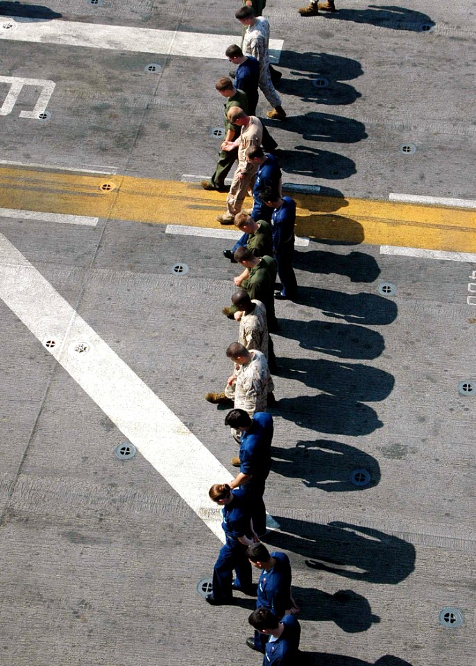 US Navy 090405-N-6410J-020 Sailors and Marines conduct a foreign object damage walk-down during flight quarters