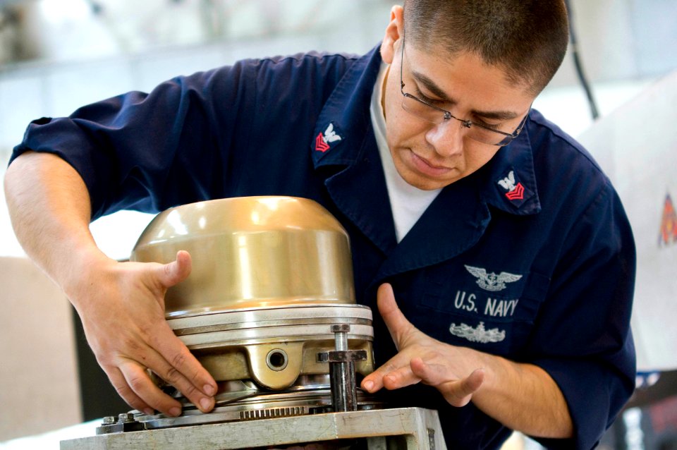 US Navy 090408-N-9552I-062 Aviation Machinist's Mate 1st Class Luis Medina slips an O-ring onto the dome of a propeller from a P-3C Orion at Naval Air Station Sigonella