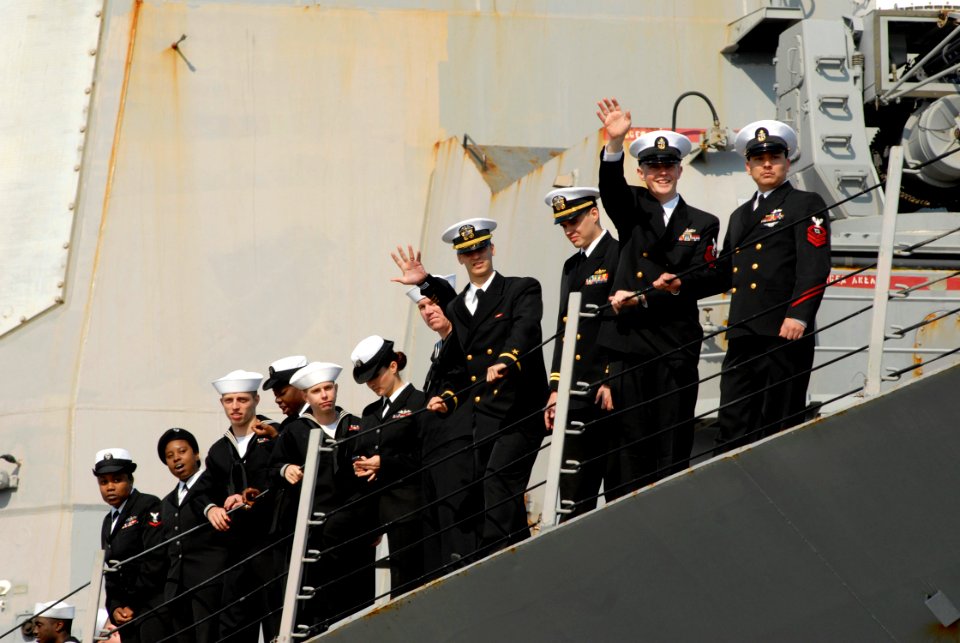 US Navy 090409-N-8907D-118 Sailors assigned to the guided-missile destroyer USS Mahan (DDG 72) wave to family members during homecoming celebrations at Naval Station Norfolk