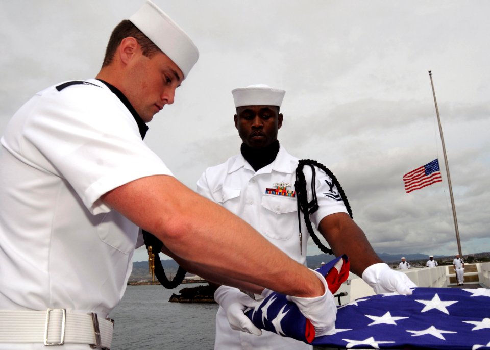 US Navy 090408-N-9758L-079 A Naval Station Pearl Harbor flag detail, folds an American flag during an ashes scattering ceremony for Pearl Harbor survivor retired Capt. Demetrius Vellis at the USS Utah Memorial on Ford Island