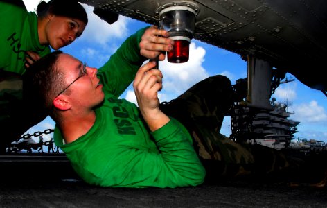US Navy 090404-N-6597H-058 Aviation Electrician's Mate 2nd Class Alan Pollard, right, from San Diego, and Aviation Electrician's Mate Airman Ashley Westcott, from Oceanside, Calif., perform preventive maintenance