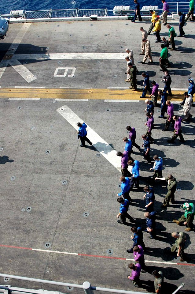 US Navy 090405-N-6410J-035 Sailors and Marines conduct a foreign object damage walk-down during flight quarters
