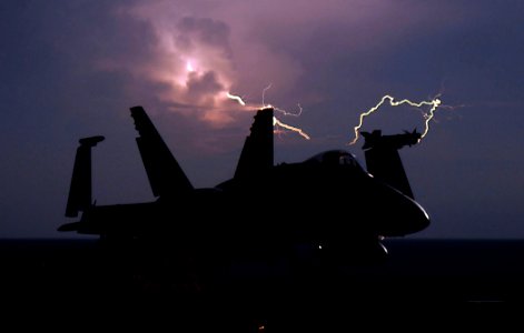 US Navy 090408-N-2610F-293 Lightning strikes behind an F-A-18C Hornet from the