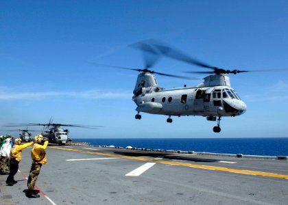 US Navy 090413-N-9520G-171 An aviation boatswain's mate (Handling) directs the takeoff of a CH-46E Sea Knight helicopter from the amphibious assault ship USS Essex (LHD 2) in support of Exercise Balikatan 09