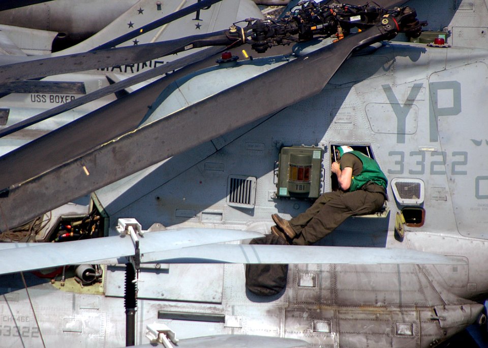 US Navy 090405-N-6410J-016 A Marine aviation mechanic conducts a pre-flight inspect on a CH-46E helicopter engine on the flight deck of the amphibious assault ship USS Boxer (LHD 4)