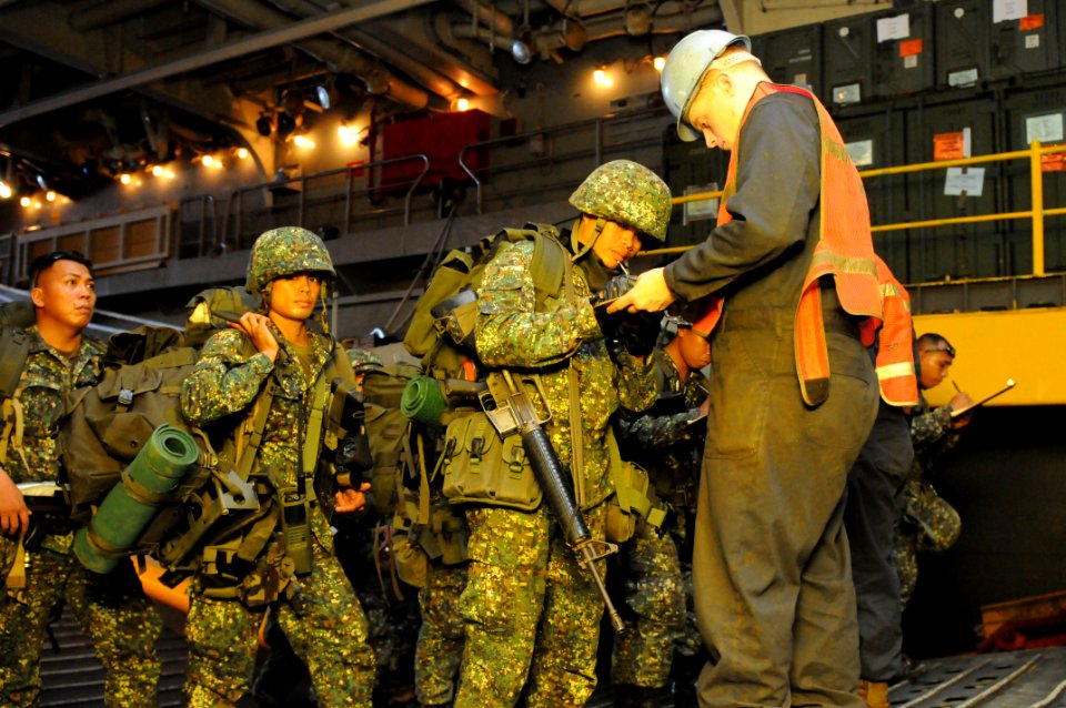 US Navy 090414-N-4010S-048 Armed Forces of the Philippines Marines assigned to the 38th Marine Company depart a landing craft utility and check in with combat cargo personnel assigned to the amphibious assault ship USS Essex (L