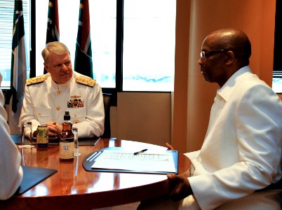 US Navy 090406-N-8273J-050 Chief of Naval Operations (CNO) Adm. Gary Roughead, left, meets with Deputy Minister of Defense Mr. Fezile Bhengu, right, during a conference call at the Defense Headquarters in Pretoria, South Africa photo