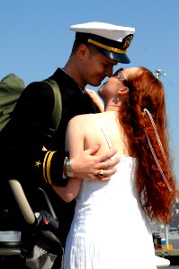 US Navy 090409-N-8907D-233 Lt. j.g. Matt Johnson, from the guided-missile destroyer USS Mahan (DDG 72), holds his wife in his arms during homecoming