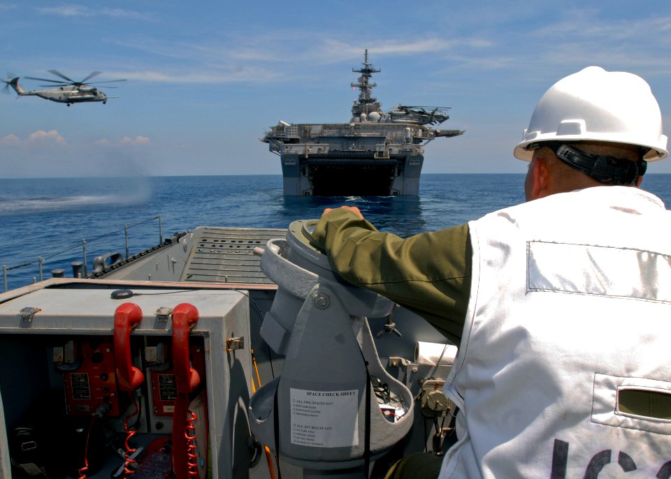US Navy 090413-N-9950J-326 Senior Chief Boatswain's Mate Terrence Asyn, assigned to Assault Craft Unit One (ACU-1), navigates a landing craft utility into the well deck of the forward-deployed amphibious assault ship USS Essex