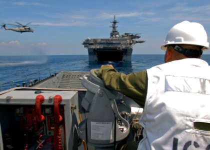 US Navy 090413-N-9950J-326 Senior Chief Boatswain's Mate Terrence Asyn, assigned to Assault Craft Unit One (ACU-1), navigates a landing craft utility into the well deck of the forward-deployed amphibious assault ship USS Essex