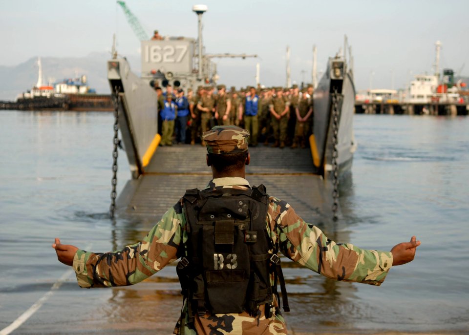 US Navy 090414-N-9520G-086 A Sailor assigned to Beach Master Unit (BMU) 1 directs Landing Craft Utility (LCU) 1627 as it comes ashore to disembark Marines assigned to the 31st Marine Expeditionary Unit (31st MEU) during Balikat